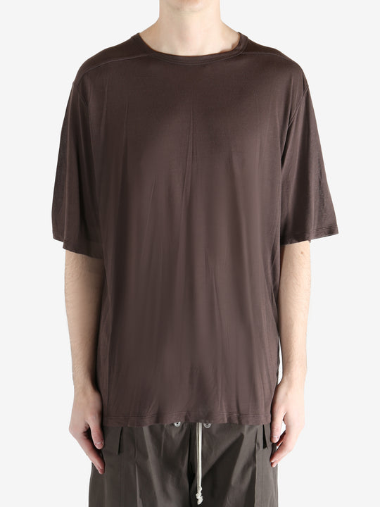 brown t-shirt worn by a person, showing the t-shirt fit