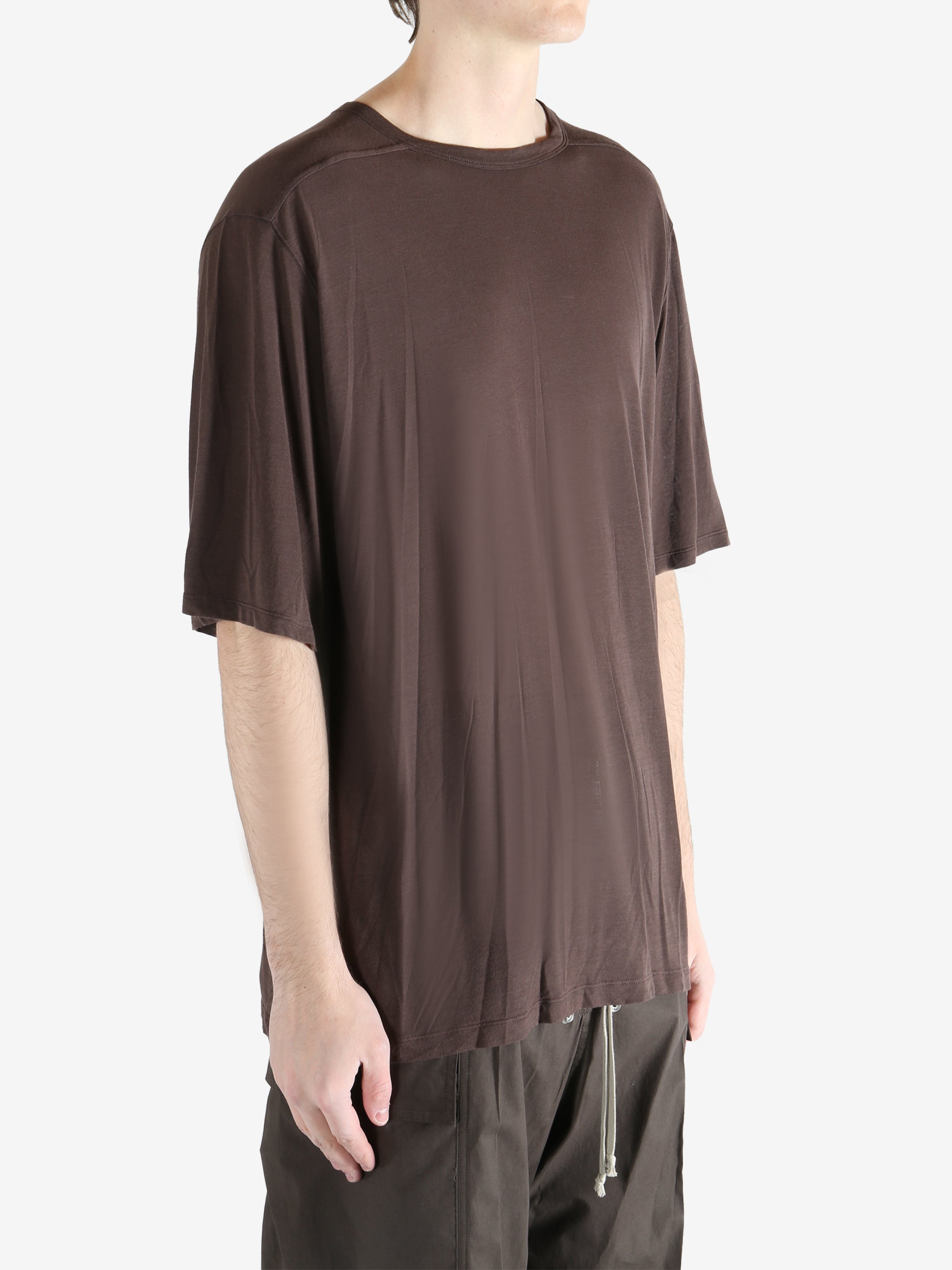 brown t-shirt worn by a person, showing the t-shirt fit