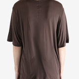 brown t-shirt worn by a person, showing the t-shirt fit