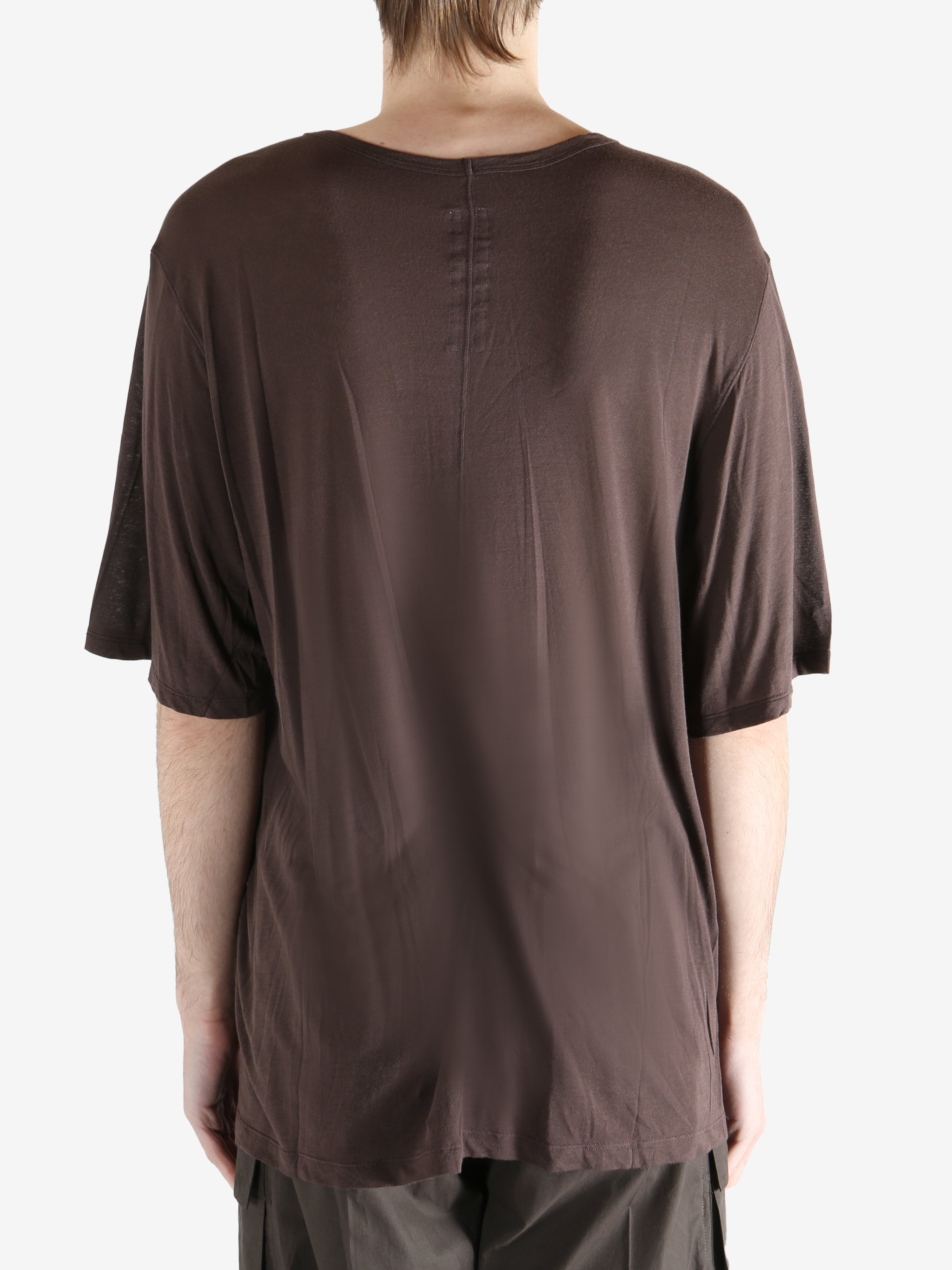 brown t-shirt worn by a person, showing the t-shirt fit
