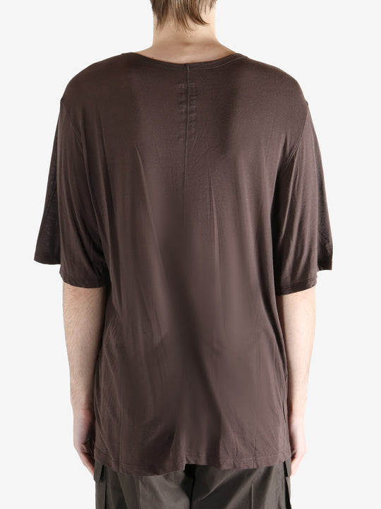 brown t-shirt worn by a person, showing the t-shirt fit