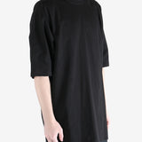 black t-shirt worn by a person, showing the t-shirt  fit