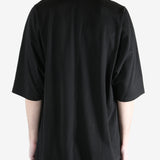 black t-shirt worn by a person, showing the t-shirt  fit