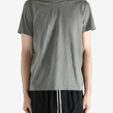 Green t-shirt worn by a person, showing the t-shirt fit