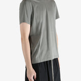 Green t-shirt worn by a person, showing the t-shirt fit