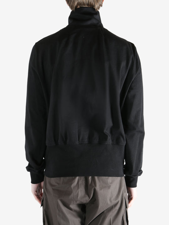 Black jacket worn by a person, showing the jacket fit