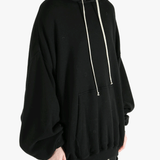 Black hoodies worn by a person, showing the hoodies fit