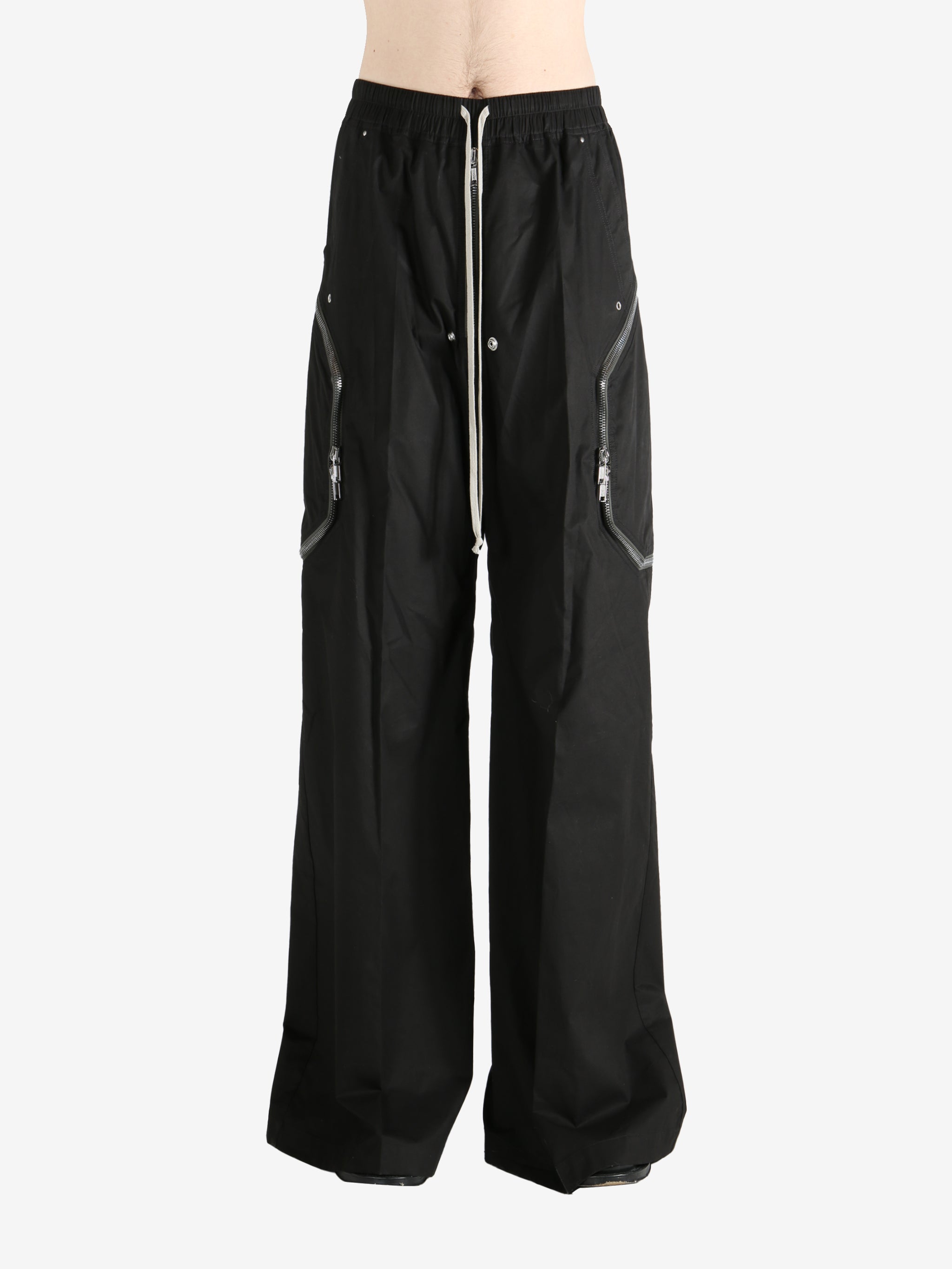 Black pants worn by a person, showing the pants' fit