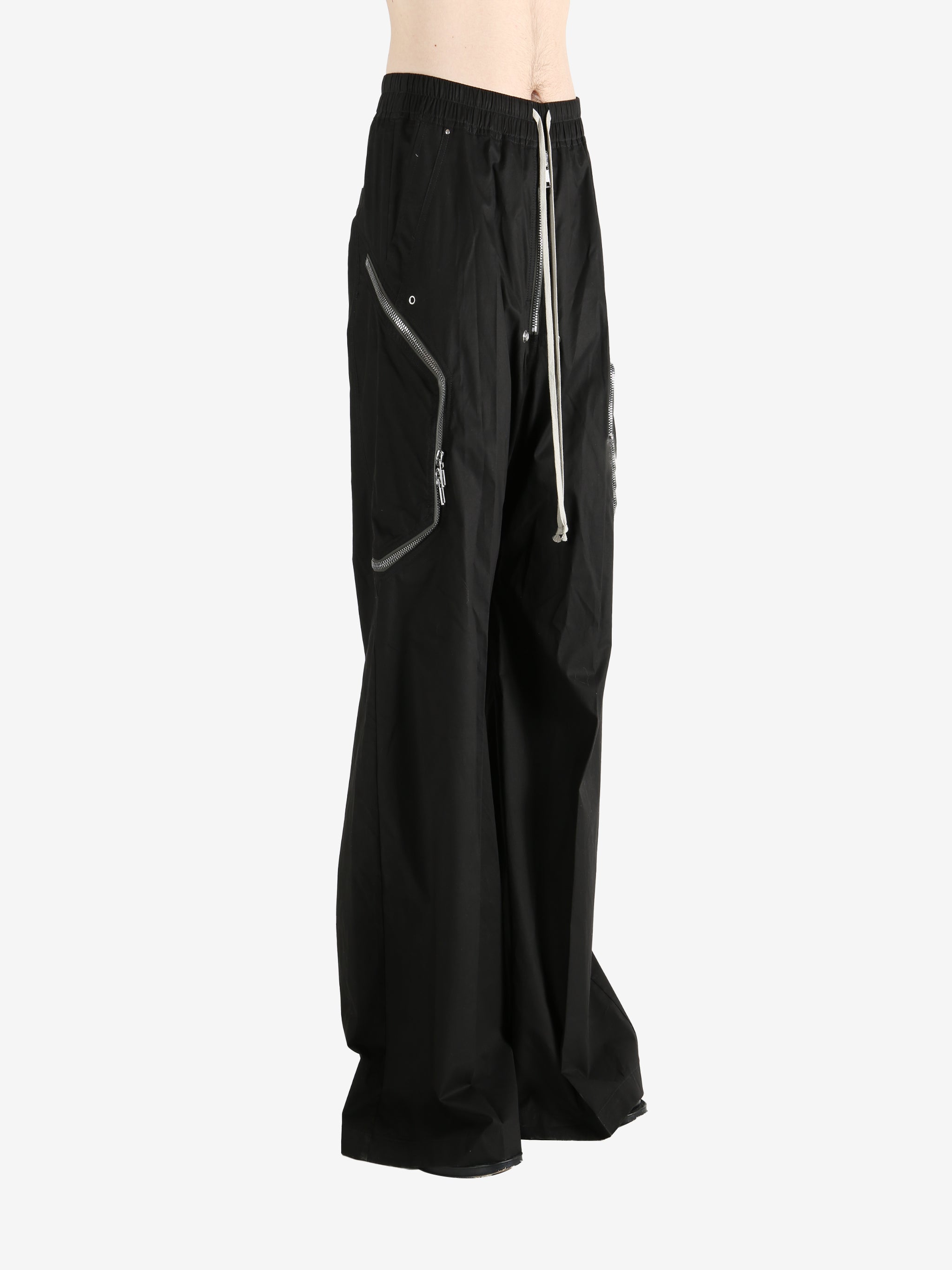 Black pants worn by a person, showing the pants' fit