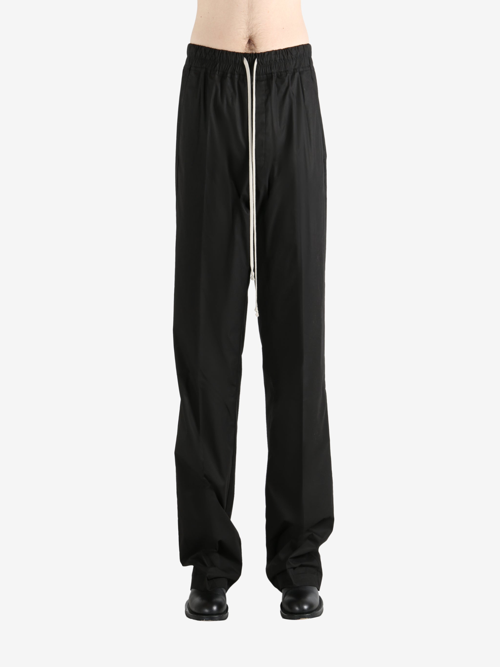 Black pants worn by a person, showing the pants' fit