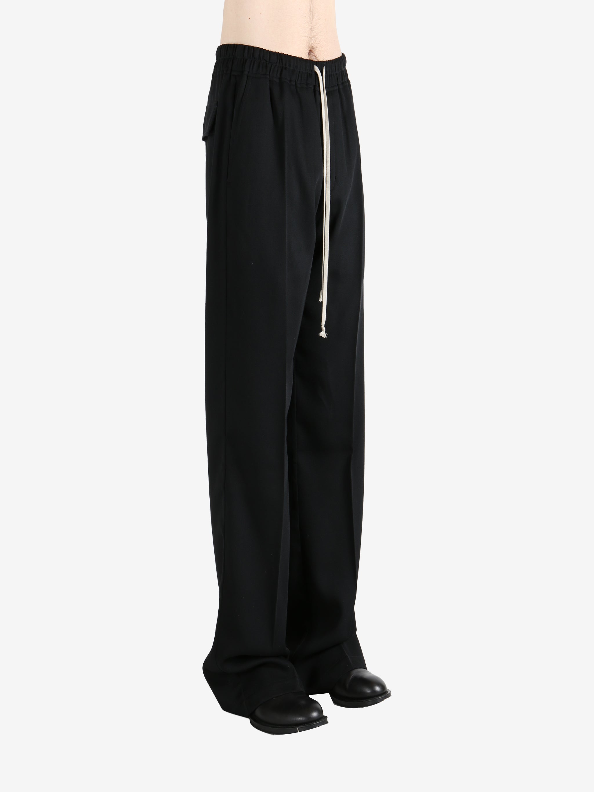 Black pants worn by a person, showing the pants' fit