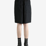 Black shorts worn by a person, showing the shorts fit