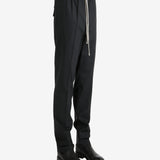 Black pants worn by a person, showing the pants' fit