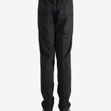 Black pants worn by a person, showing the pants' fit