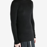 Black shirts worn by a person, showing the shirts fit