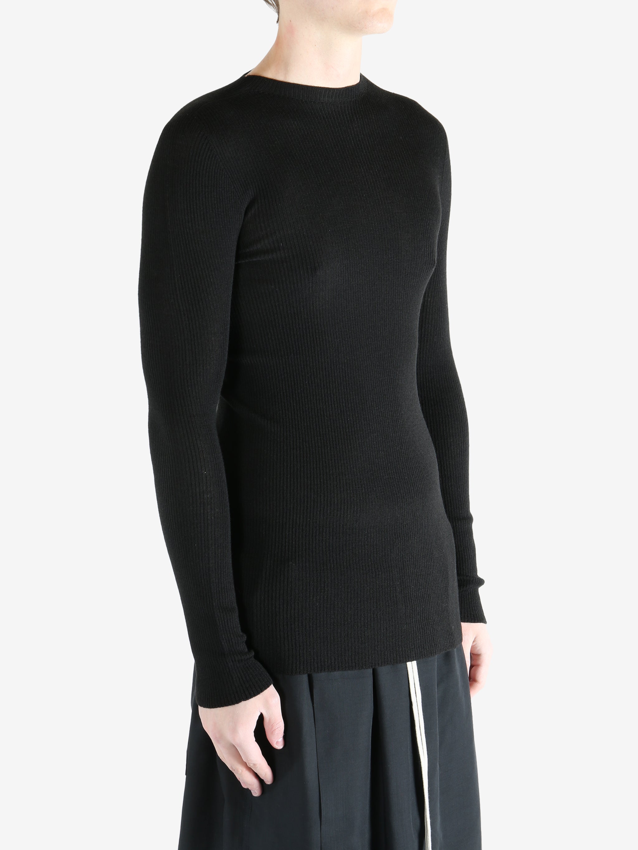 Black shirts worn by a person, showing the shirts fit