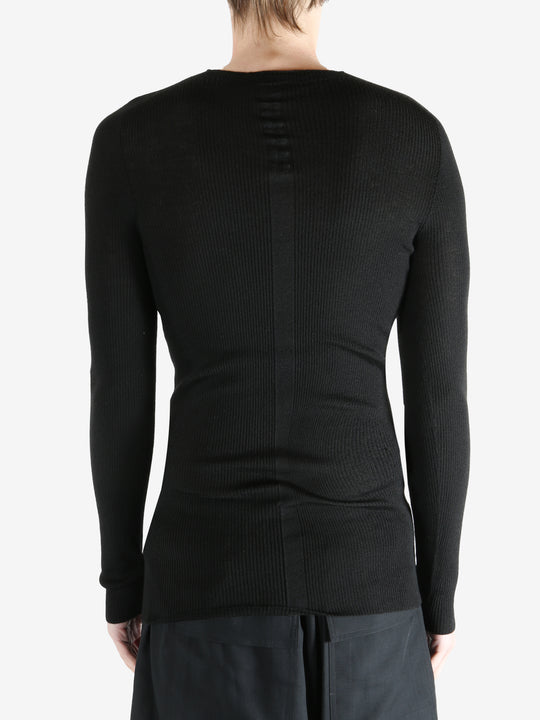 Black shirts worn by a person, showing the shirts fit