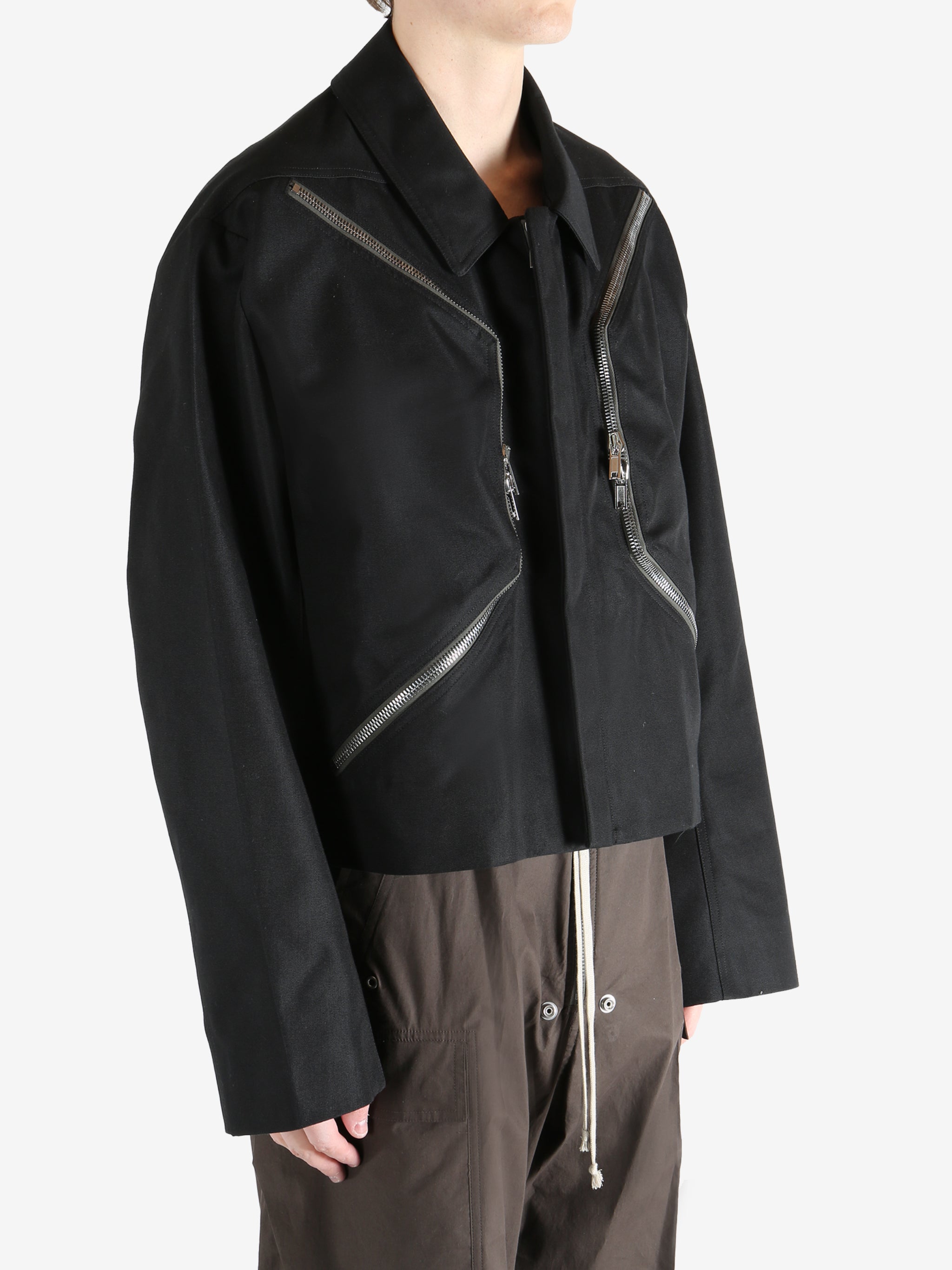 Black jacket worn by a person, showing the jacket fit