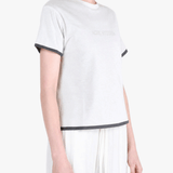 White t-shirt worn by a person, showing the t-shirt fit