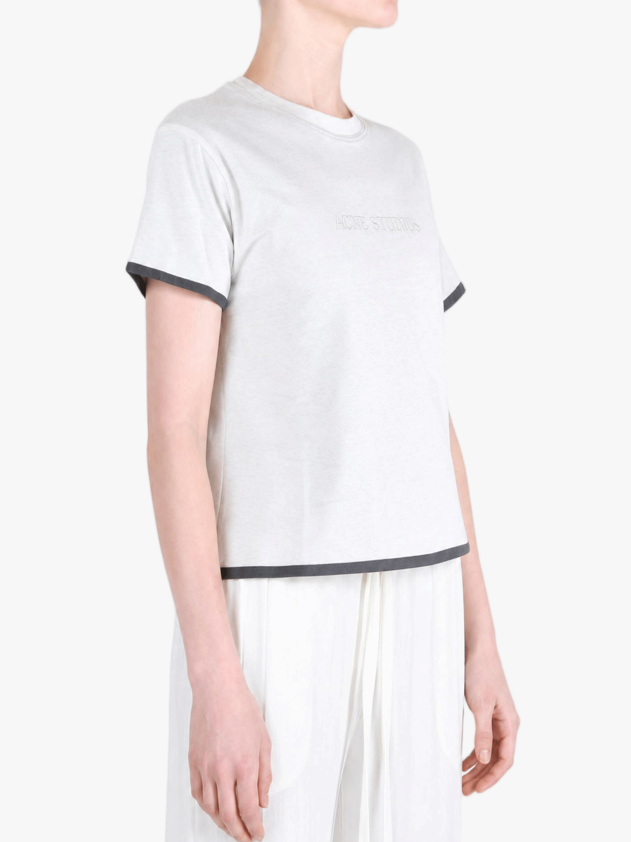 White t-shirt worn by a person, showing the t-shirt fit