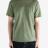 Green t-shirt worn by a person, showing the t-shirt fit