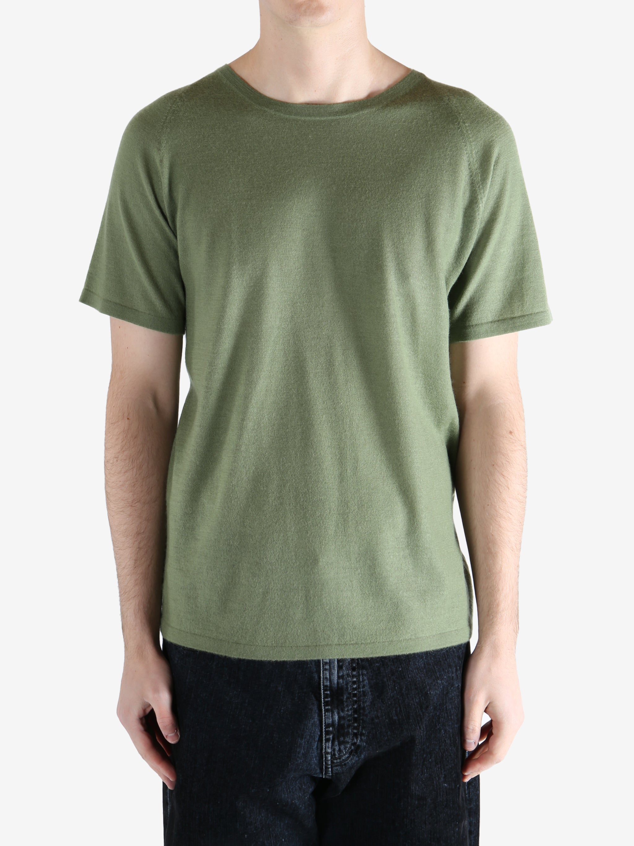 Green t-shirt worn by a person, showing the t-shirt fit
