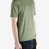 Green t-shirt worn by a person, showing the t-shirt fit