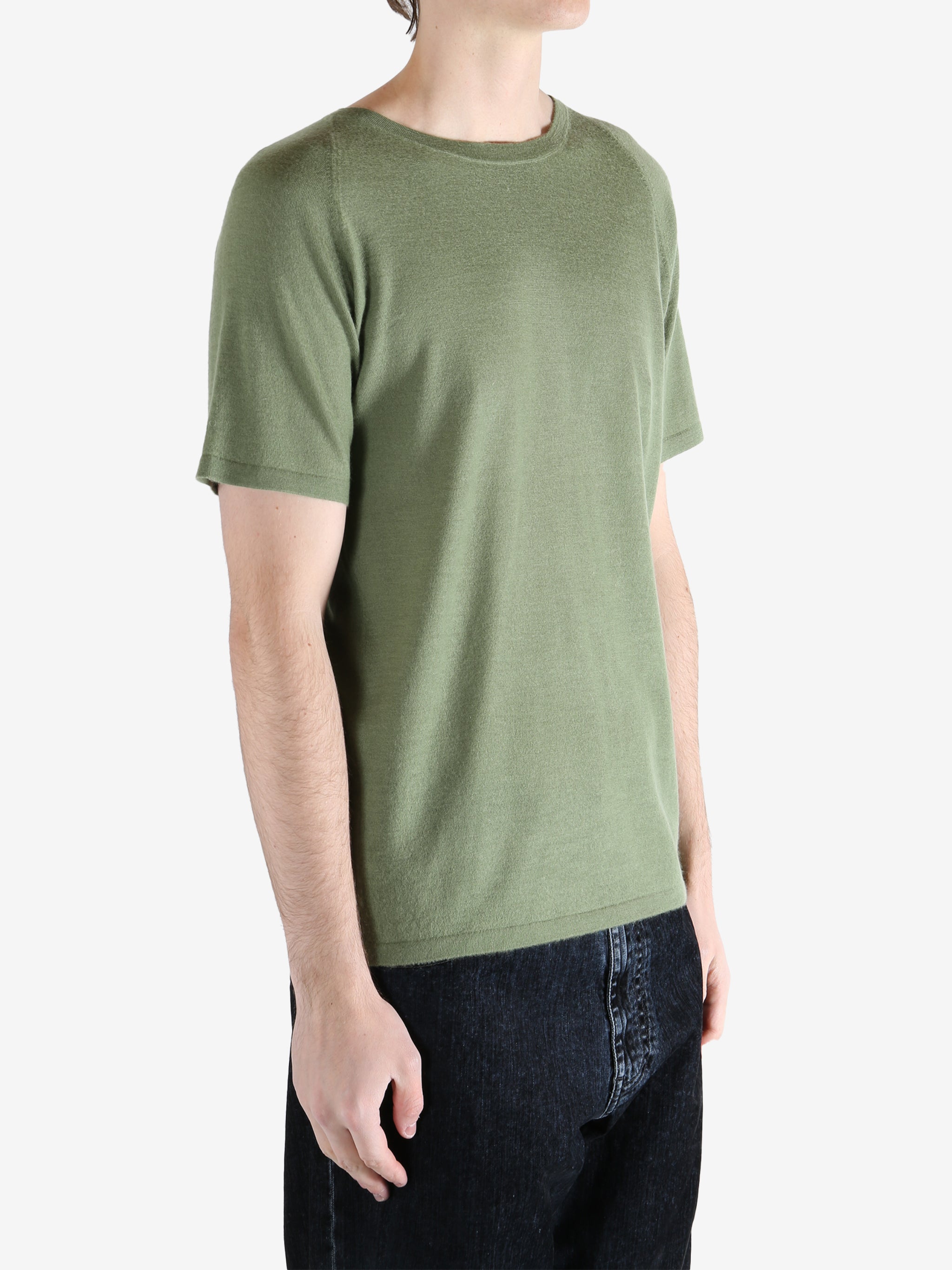 Green t-shirt worn by a person, showing the t-shirt fit