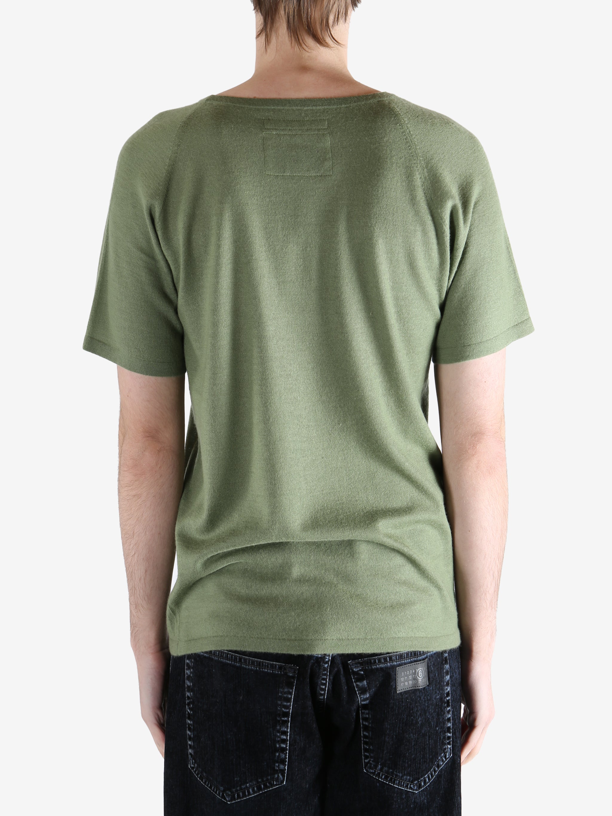 Green t-shirt worn by a person, showing the t-shirt fit
