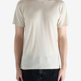 white t-shirt worn by a person, showing the t-shirt fit