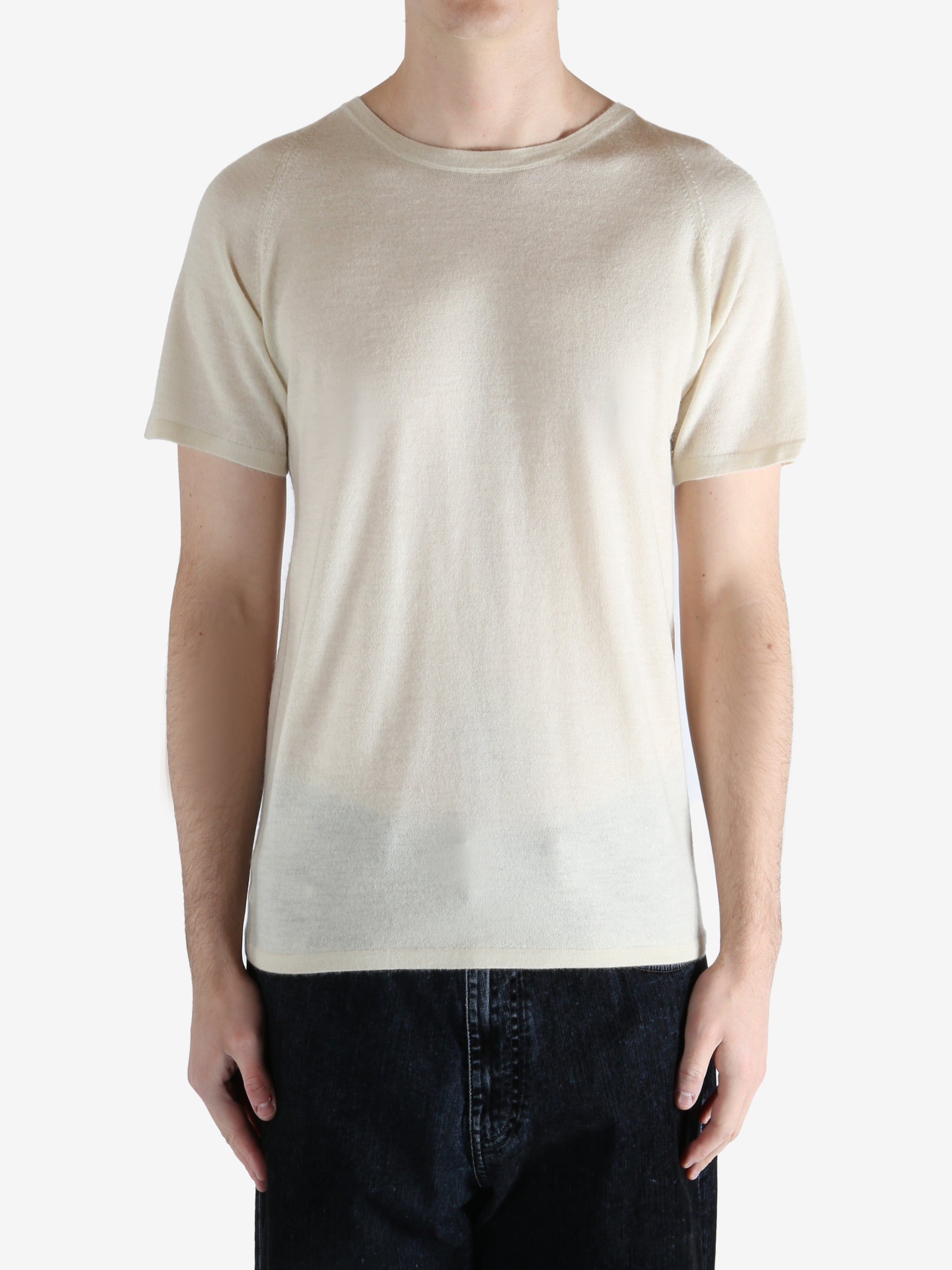 white t-shirt worn by a person, showing the t-shirt fit