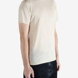 white t-shirt worn by a person, showing the t-shirt fit