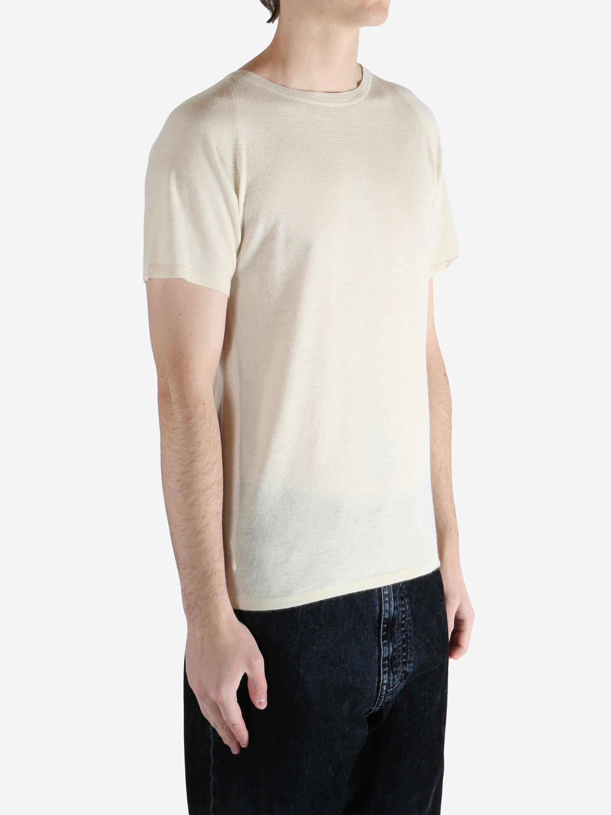 white t-shirt worn by a person, showing the t-shirt fit