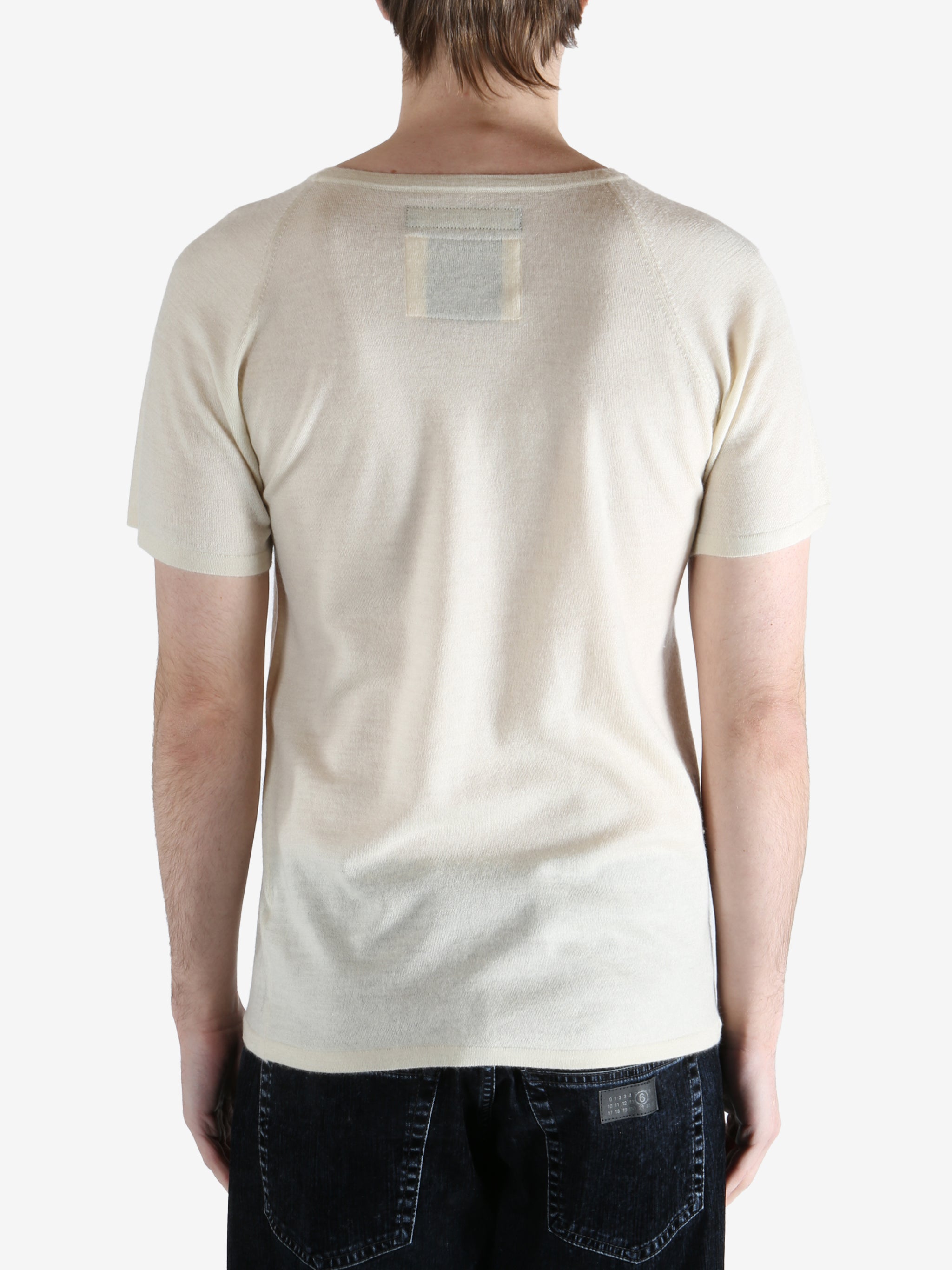 white t-shirt worn by a person, showing the t-shirt fit