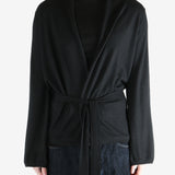 Black coat worn by a person, showing the coat's fit