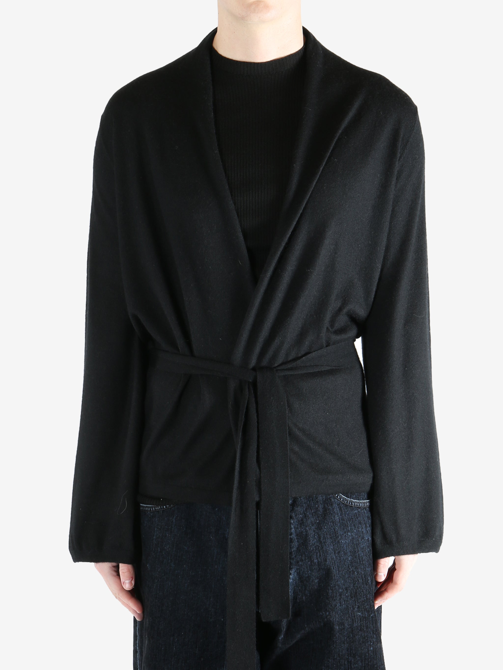 Black coat worn by a person, showing the coat's fit