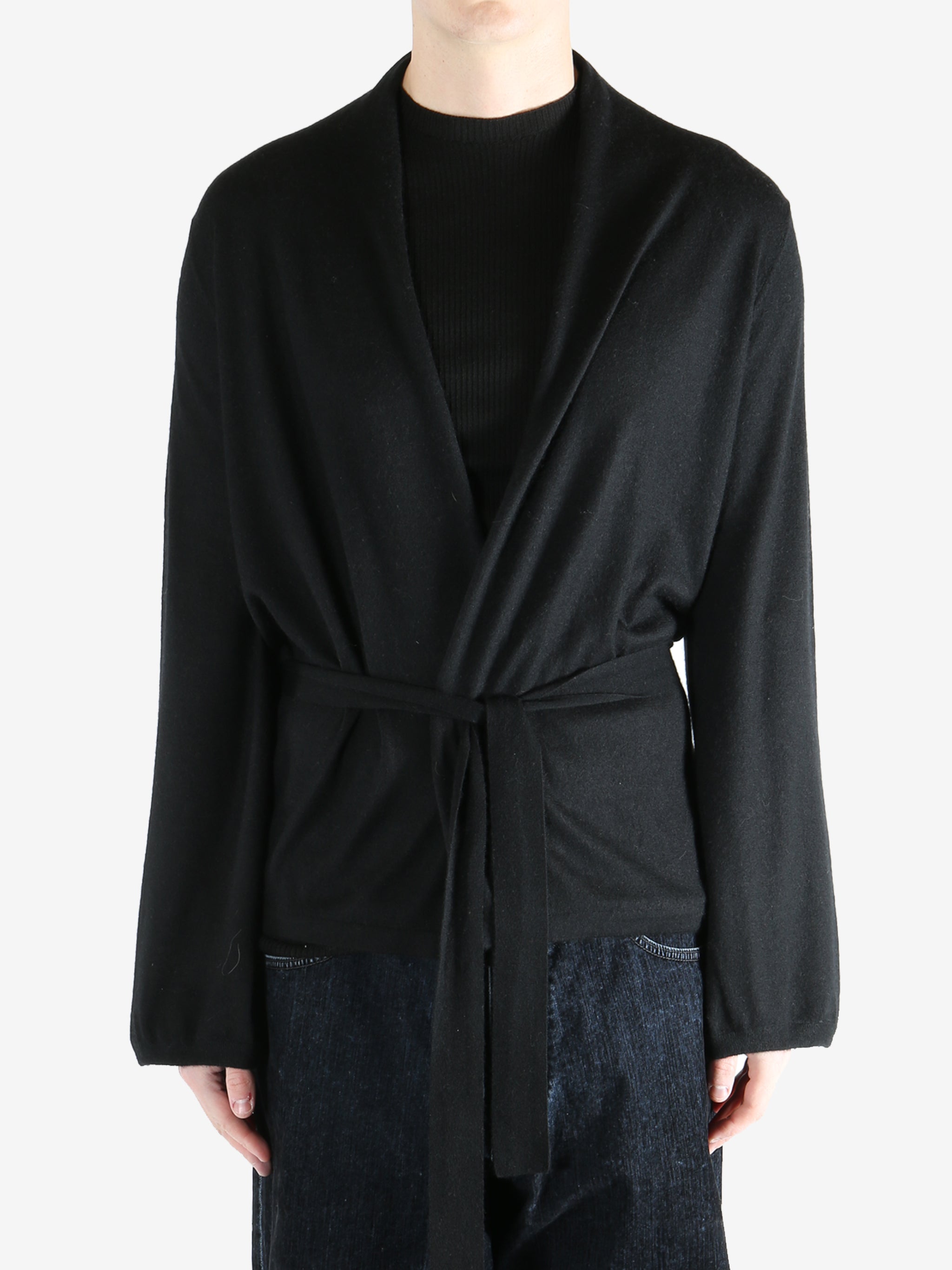 Black coat worn by a person, showing the coat's fit