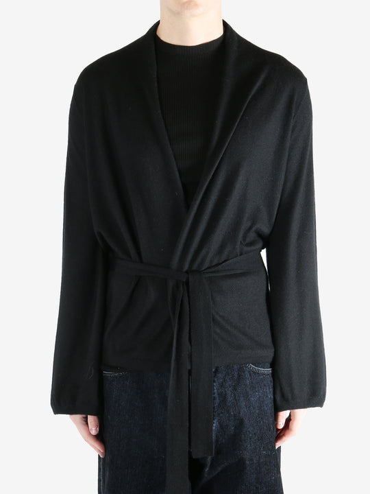 Black coat worn by a person, showing the coat's fit