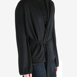 Black coat worn by a person, showing the coat's fit