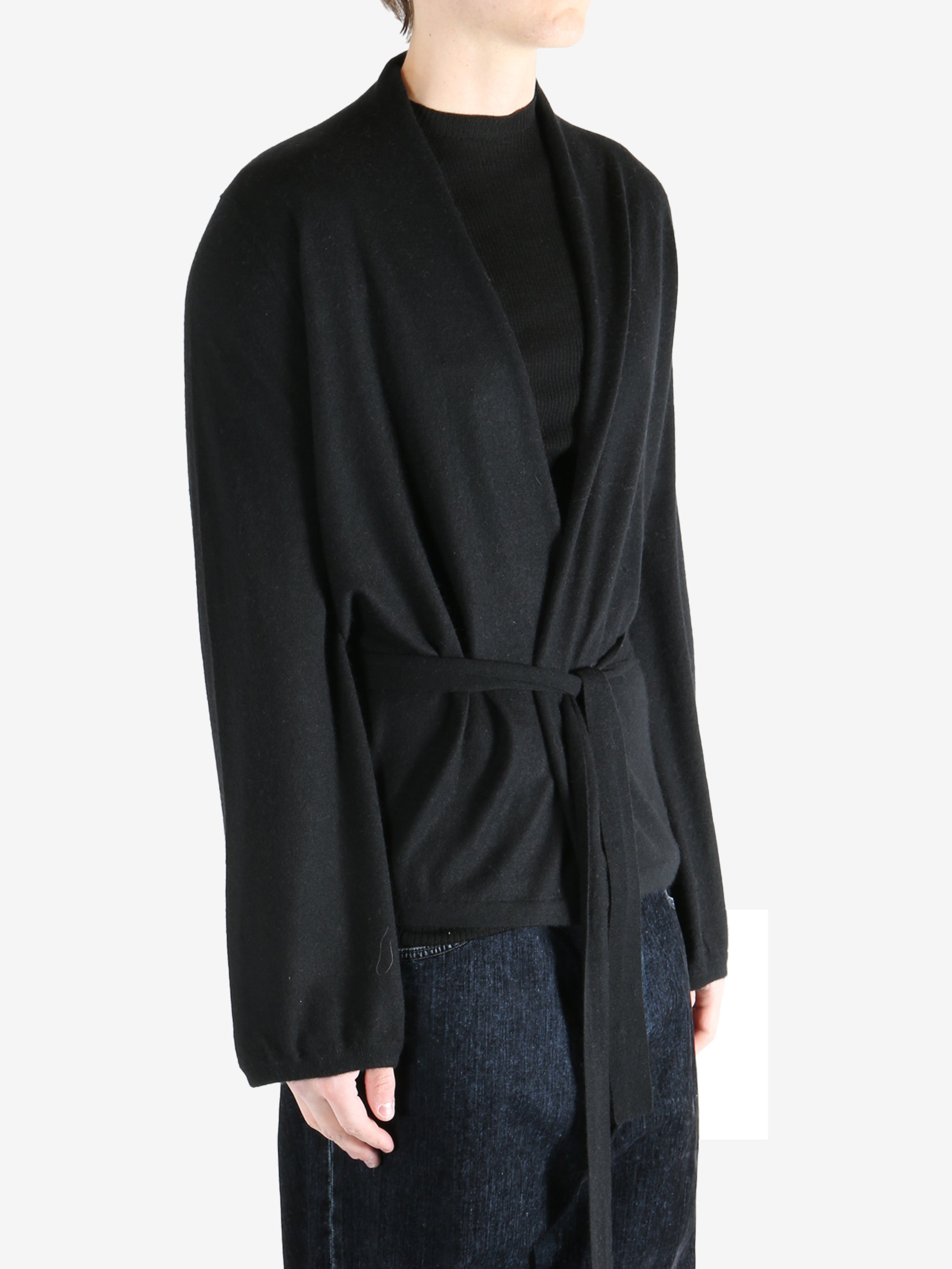 Black coat worn by a person, showing the coat's fit