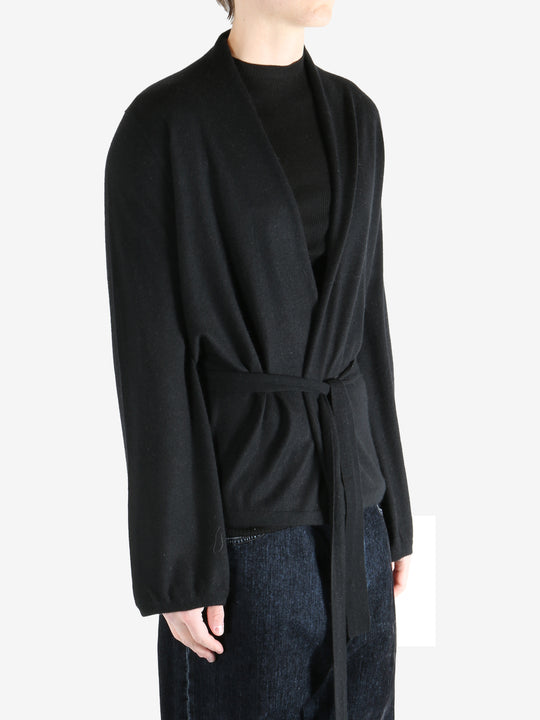 Black coat worn by a person, showing the coat's fit