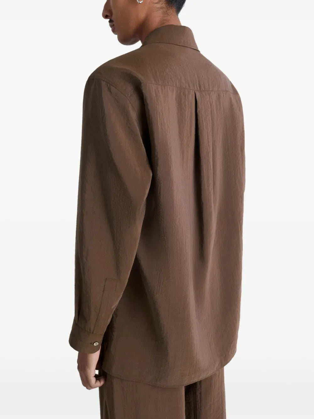 Brown shirt worn by a person, showing the shirt's fit