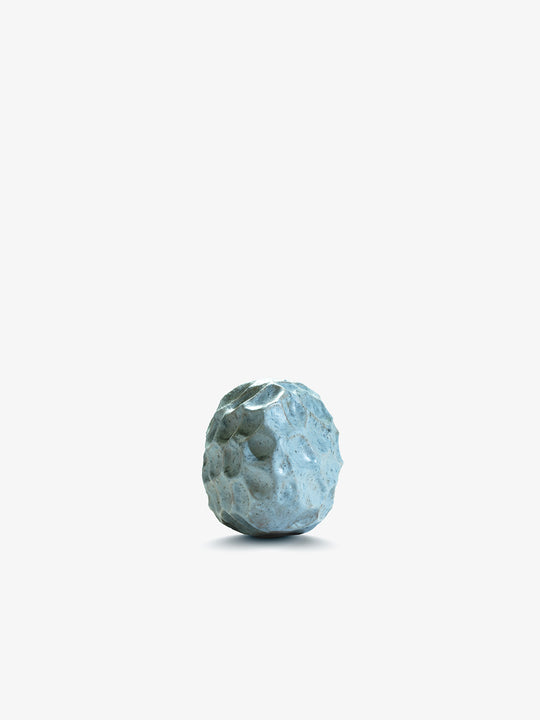 Ann Shure ceramic stone vase in azure glaze, angled view showing sculpted organic surface.