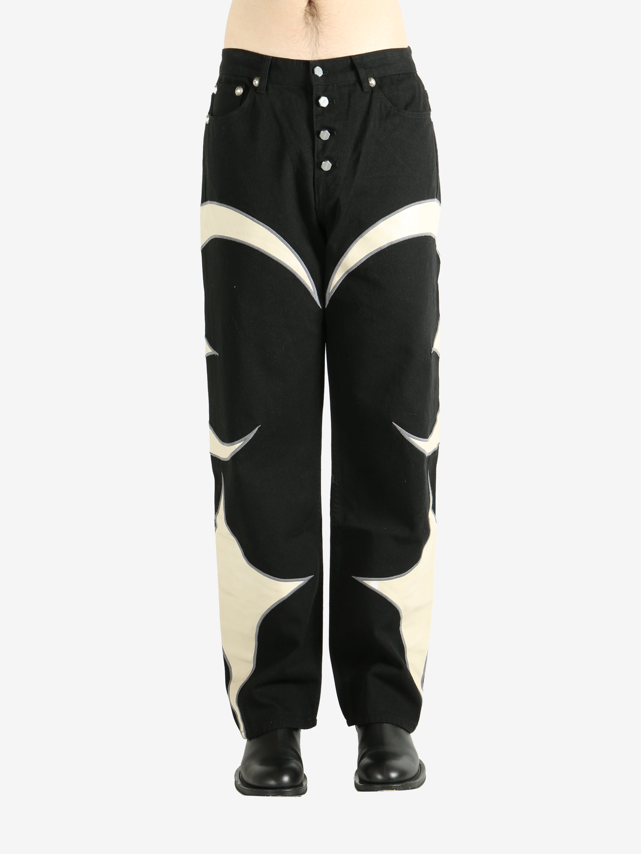 Black pants worn by a person, showing the pants' fit