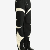 Black pants worn by a person, showing the pants' fit
