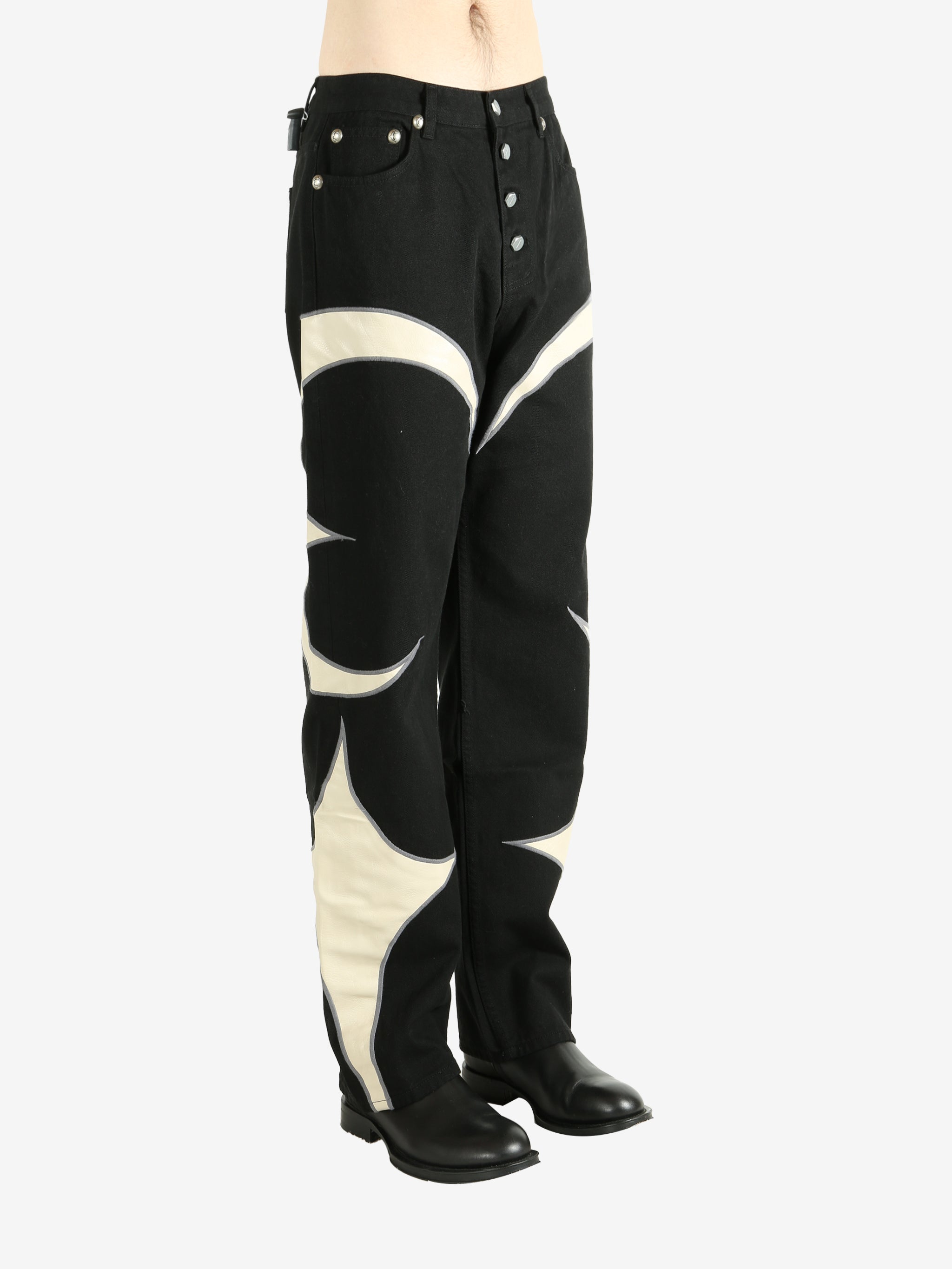 Black pants worn by a person, showing the pants' fit