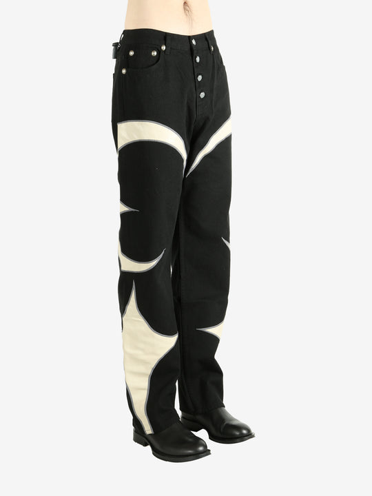 Black pants worn by a person, showing the pants' fit