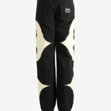 Black pants worn by a person, showing the pants' fit