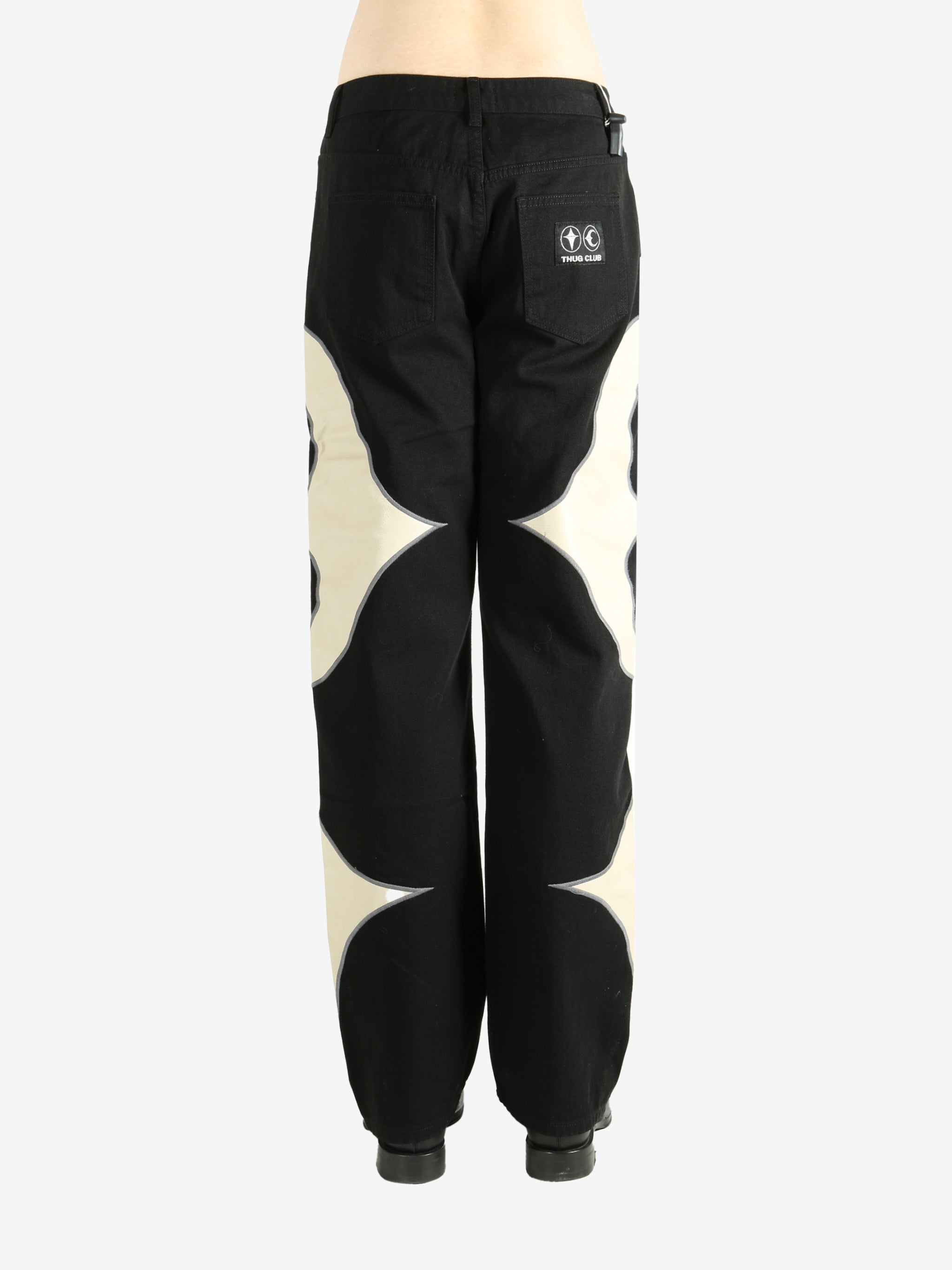 Black pants worn by a person, showing the pants' fit