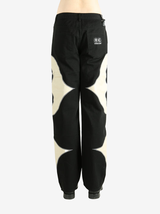 Black pants worn by a person, showing the pants' fit